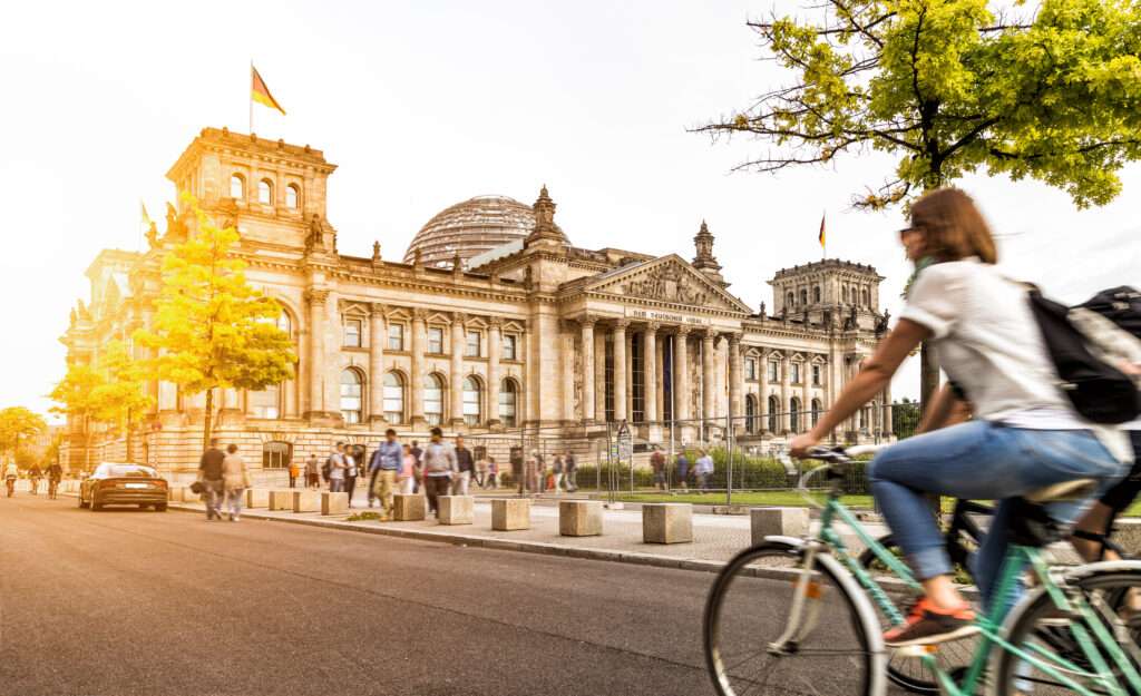 Frau auf einem Fahrrad vor dem Bundestag in Berlin